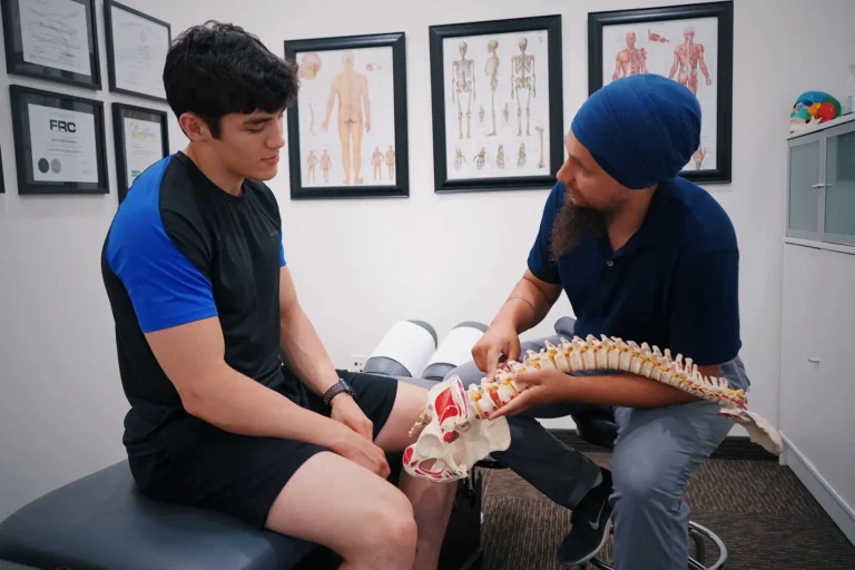 Digital marketing services: chiropractor explaining a spine model to a patient
