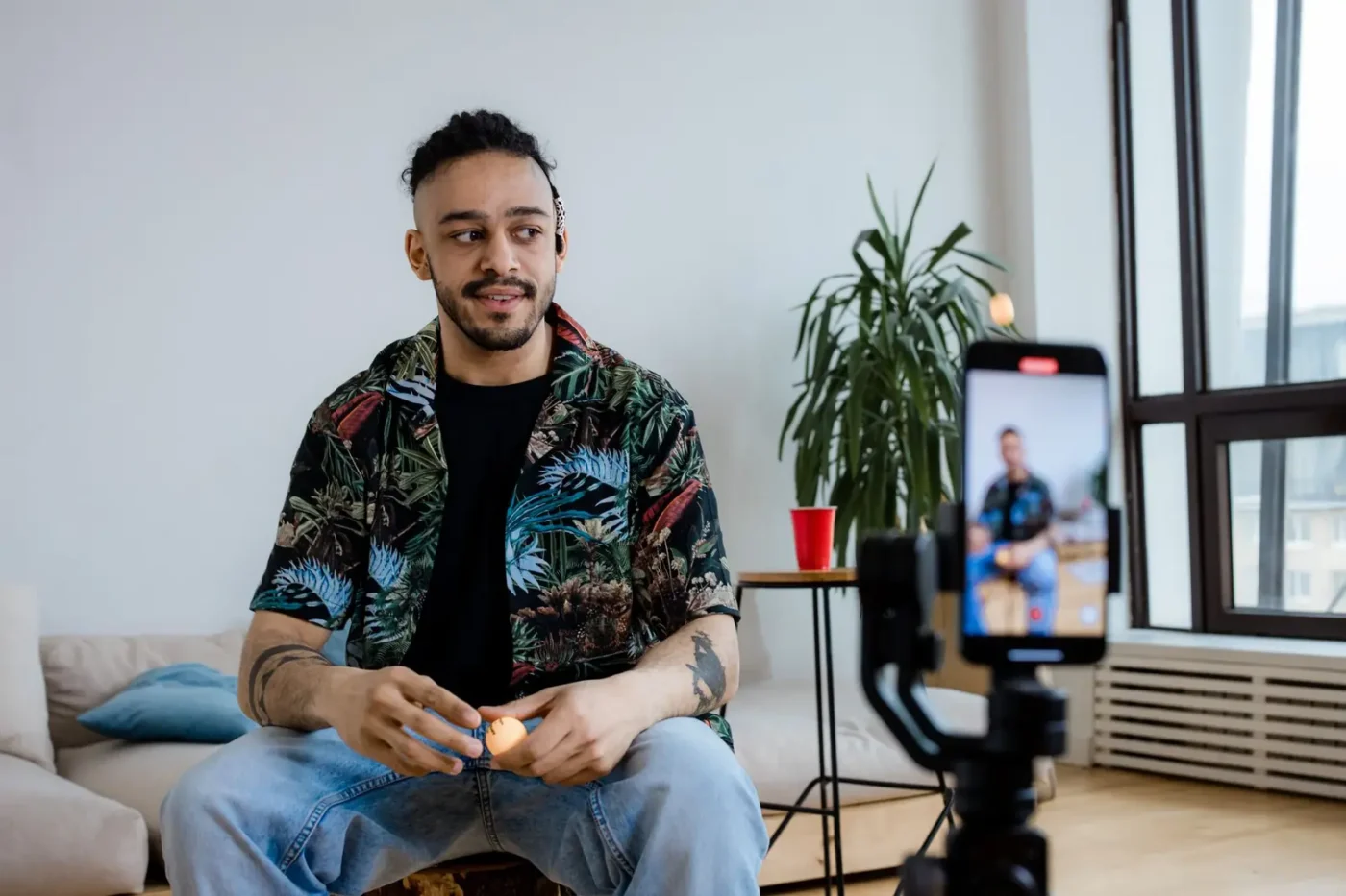 Man recording a short video on a phone mounted on a tripod Social media marketing services: man recording a short video on a phone mounted on a tripod