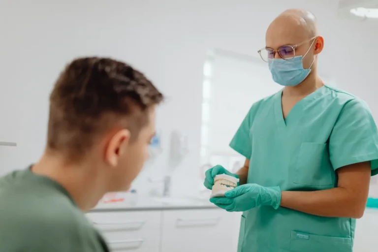 Digital marketing company: dentist showing a dental model to a patient