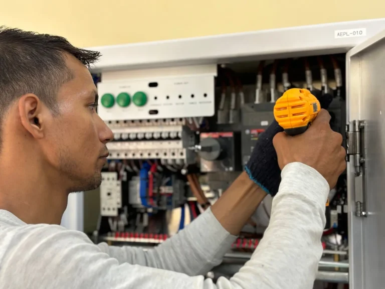 Home services marketing: electrician using a drill on an electrical panel