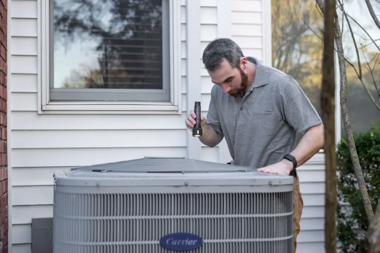Digital marketing agency: HVAC technician inspecting an outdoor air conditioning unit beside a home