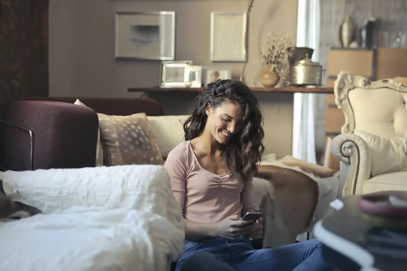 AI SEO services: woman using her phone on a living room sofa