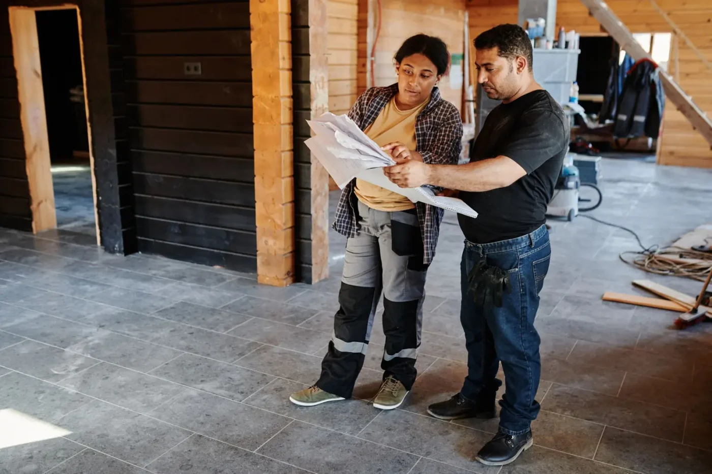 Remodeling marketing: contractors reviewing plans inside a home under renovation