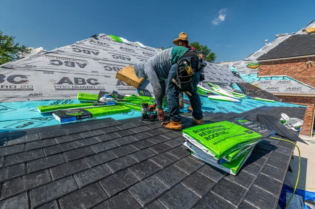 Roofers installing underlayment and shingles on a house Roofing marketing: roofers installing underlayment and shingles on a house