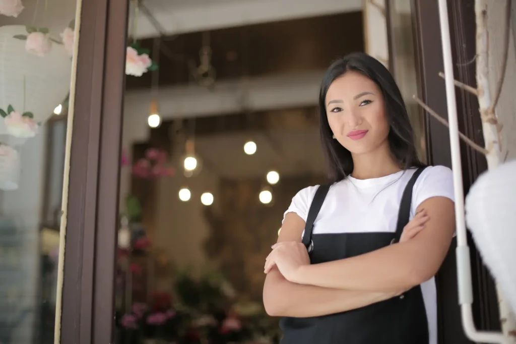 Google Business Profile optimization: shop owner standing at the entrance of her store