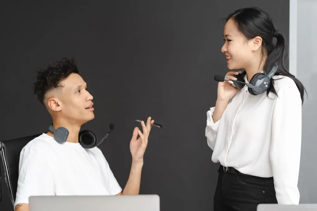 Reputation management services: team members with headsets chatting in the office