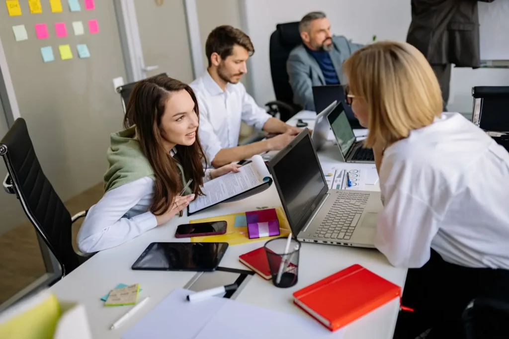 Local SEO Charleston: team members comparing notes on laptops at a shared desk