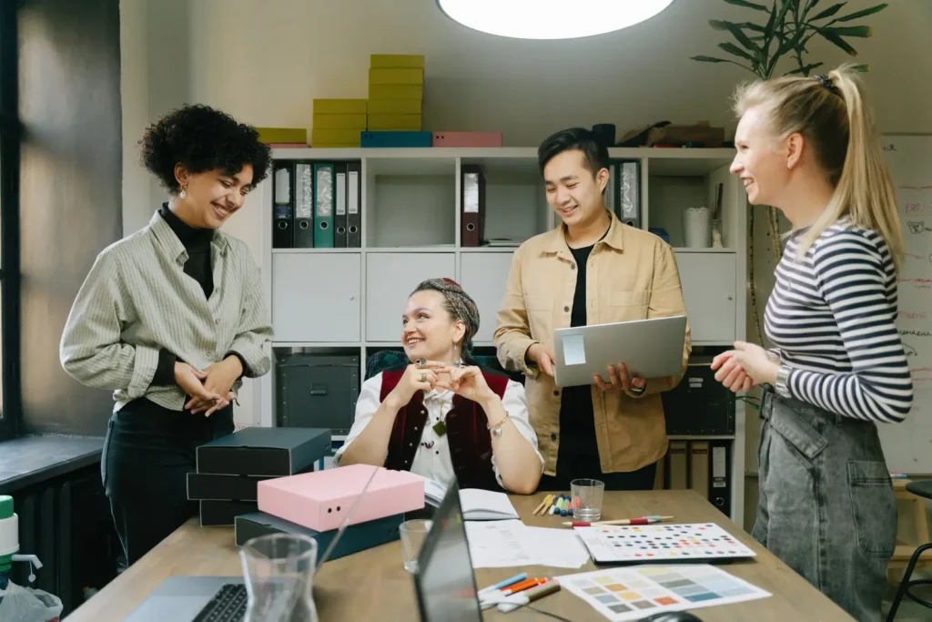 AI SEO services: colleagues gathered around a desk reviewing work in a bright office
